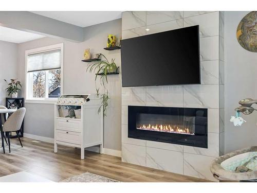 7128 Hunterwood Road Nw, Calgary, AB - Indoor Photo Showing Living Room With Fireplace