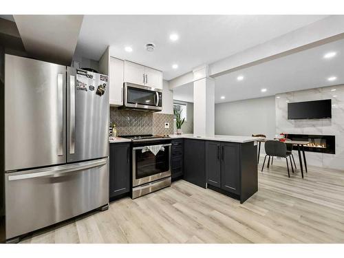 7128 Hunterwood Road Nw, Calgary, AB - Indoor Photo Showing Kitchen With Stainless Steel Kitchen With Upgraded Kitchen