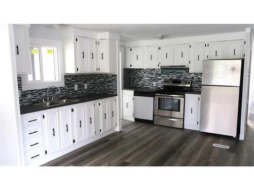 251 4 Street Nw, Sundre, AB - Indoor Photo Showing Kitchen With Double Sink