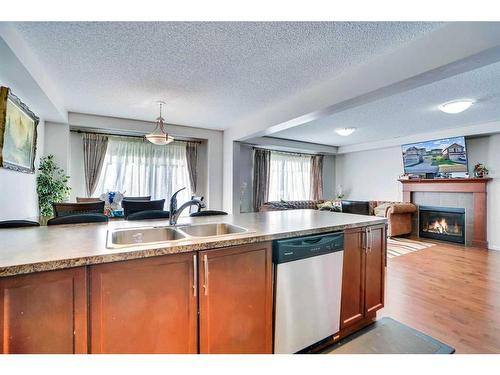 209 Windford Park Sw, Airdrie, AB - Indoor Photo Showing Kitchen With Fireplace With Double Sink