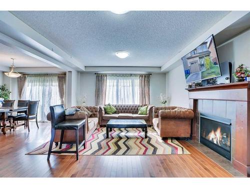 209 Windford Park Sw, Airdrie, AB - Indoor Photo Showing Living Room With Fireplace