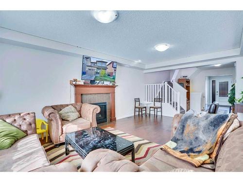 209 Windford Park Sw, Airdrie, AB - Indoor Photo Showing Living Room With Fireplace