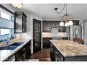 228 Sheep River Lane, Okotoks, AB  - Indoor Photo Showing Kitchen With Double Sink With Upgraded Kitchen 