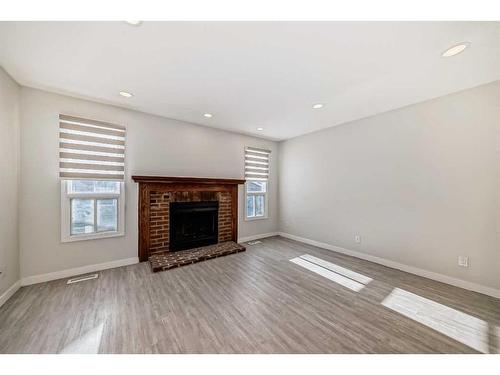 1131 Millcrest Rise Sw, Calgary, AB - Indoor Photo Showing Living Room With Fireplace