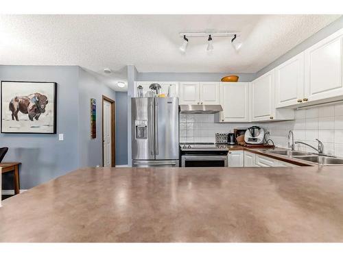 131 Millview Square Sw, Calgary, AB - Indoor Photo Showing Kitchen With Double Sink