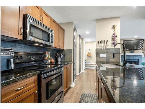 1-105 Village Heights Sw, Calgary, AB - Indoor Photo Showing Kitchen With Stainless Steel Kitchen