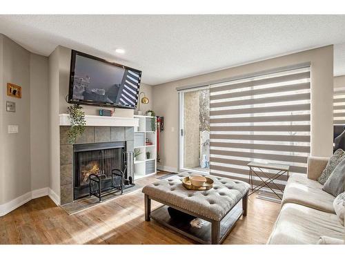 1-105 Village Heights Sw, Calgary, AB - Indoor Photo Showing Living Room With Fireplace