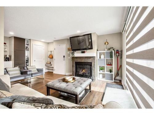 1-105 Village Heights Sw, Calgary, AB - Indoor Photo Showing Living Room With Fireplace