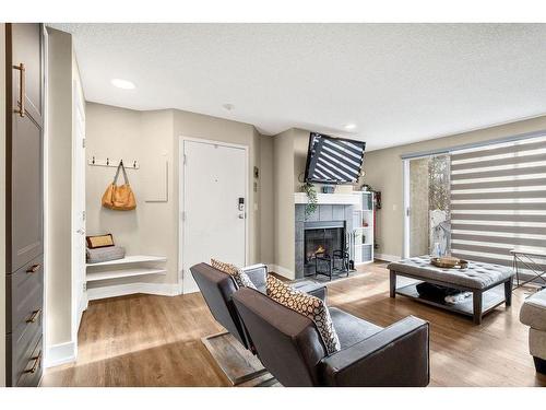 1-105 Village Heights Sw, Calgary, AB - Indoor Photo Showing Living Room With Fireplace