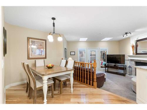 8 Shawnee Way Sw, Calgary, AB - Indoor Photo Showing Dining Room With Fireplace