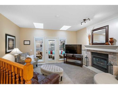 8 Shawnee Way Sw, Calgary, AB - Indoor Photo Showing Living Room With Fireplace