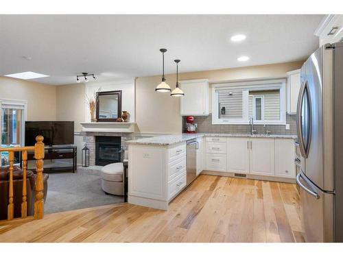 8 Shawnee Way Sw, Calgary, AB - Indoor Photo Showing Kitchen With Fireplace