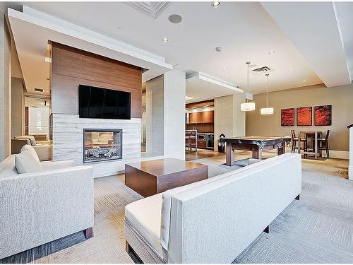 311-51 Waterfront Mews Sw, Calgary, AB - Indoor Photo Showing Living Room With Fireplace