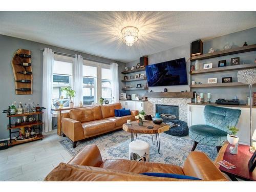 1186 Coopers Drive Sw, Airdrie, AB - Indoor Photo Showing Living Room With Fireplace