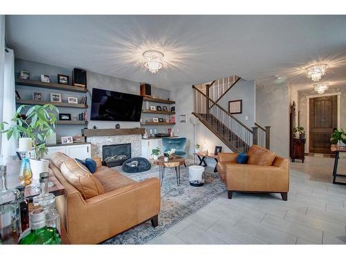 1186 Coopers Drive Sw, Airdrie, AB - Indoor Photo Showing Living Room With Fireplace