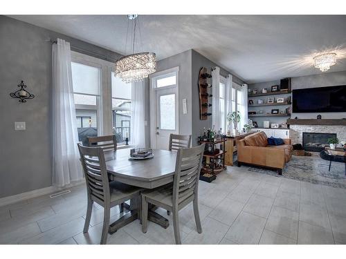 1186 Coopers Drive Sw, Airdrie, AB - Indoor Photo Showing Dining Room With Fireplace