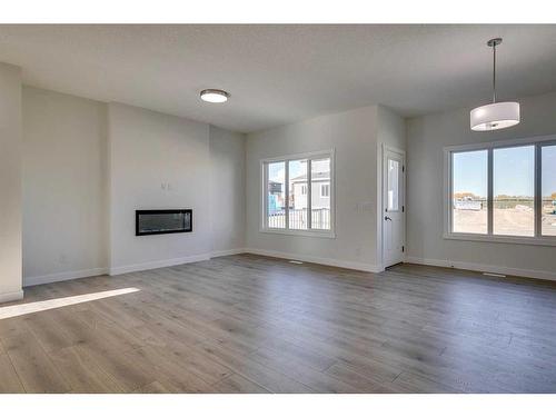 206 Blackstone Road, Balzac, AB - Indoor Photo Showing Living Room With Fireplace