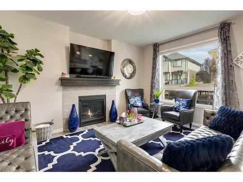 102 Hillcrest Heights Sw, Airdrie, AB - Indoor Photo Showing Living Room With Fireplace