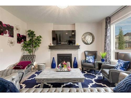 102 Hillcrest Heights Sw, Airdrie, AB - Indoor Photo Showing Living Room With Fireplace