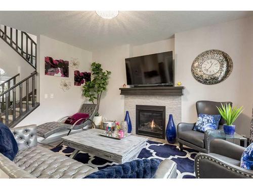 102 Hillcrest Heights Sw, Airdrie, AB - Indoor Photo Showing Living Room With Fireplace