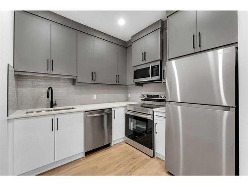 7106 36 Avenue Nw, Calgary, AB - Indoor Photo Showing Kitchen With Stainless Steel Kitchen With Double Sink