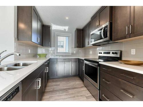 105 Trasimeno Crescent Sw, Calgary, AB - Indoor Photo Showing Kitchen With Double Sink With Upgraded Kitchen