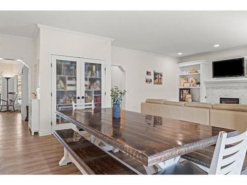 50 Crystalridge Crescent, Okotoks, AB - Indoor Photo Showing Dining Room With Fireplace