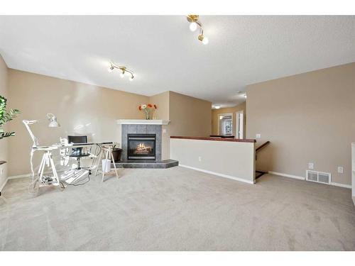 396 Rocky Ridge Drive Nw, Calgary, AB - Indoor Photo Showing Living Room With Fireplace