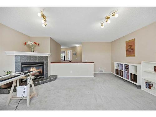 396 Rocky Ridge Drive Nw, Calgary, AB - Indoor Photo Showing Living Room With Fireplace