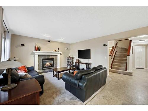 396 Rocky Ridge Drive Nw, Calgary, AB - Indoor Photo Showing Living Room With Fireplace