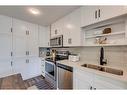 1201-350 Livingston Common Ne, Calgary, AB  - Indoor Photo Showing Kitchen With Stainless Steel Kitchen With Double Sink 