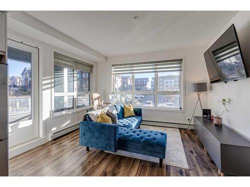 1201-350 Livingston Common Ne, Calgary, AB - Indoor Photo Showing Living Room