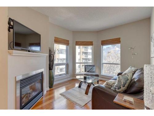 305-108 15 Avenue Se, Calgary, AB - Indoor Photo Showing Living Room With Fireplace