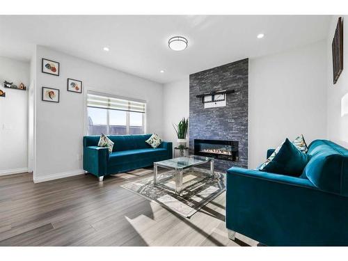 289 Corner Meadows Way Ne, Calgary, AB - Indoor Photo Showing Living Room With Fireplace