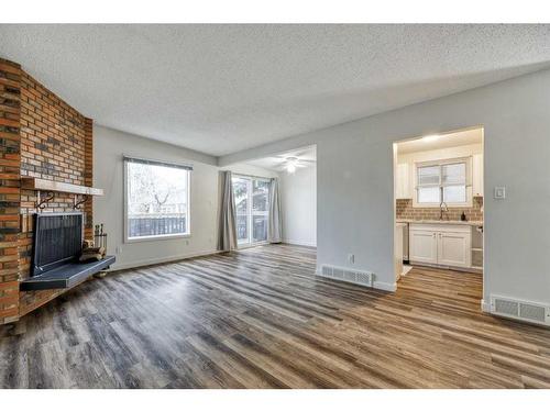 2233 3 Avenue Nw, Calgary, AB - Indoor Photo Showing Living Room With Fireplace