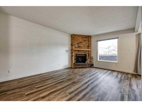 2233 3 Avenue Nw, Calgary, AB - Indoor Photo Showing Living Room With Fireplace