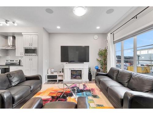 851 Carrington Boulevard Nw, Calgary, AB - Indoor Photo Showing Living Room With Fireplace