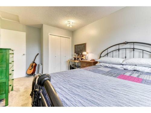 4-101 Elm Place, Okotoks, AB - Indoor Photo Showing Bedroom