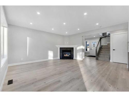 163 Springmere Way, Chestermere, AB - Indoor Photo Showing Living Room With Fireplace