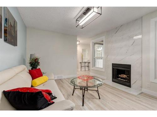 63-3200 60 Street Ne, Calgary, AB - Indoor Photo Showing Living Room With Fireplace