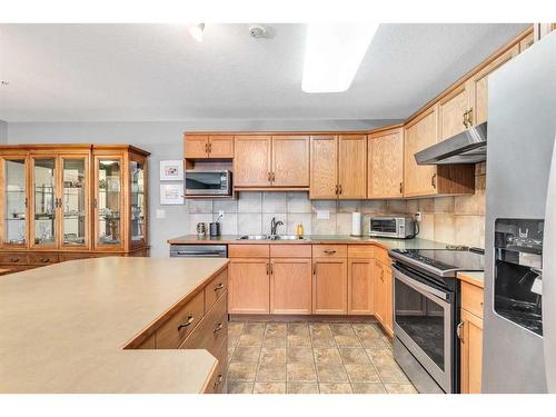 1315-303 Arbour Crest Drive Nw, Calgary, AB - Indoor Photo Showing Kitchen With Stainless Steel Kitchen With Double Sink