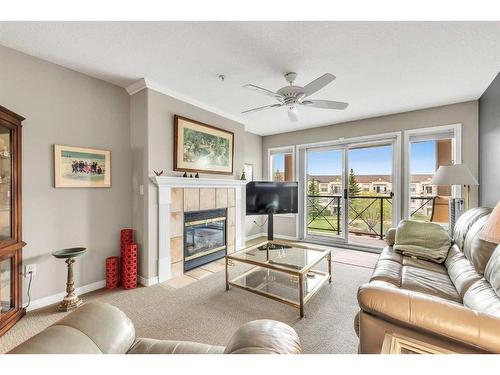 1315-303 Arbour Crest Drive Nw, Calgary, AB - Indoor Photo Showing Living Room With Fireplace