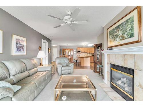 1315-303 Arbour Crest Drive Nw, Calgary, AB - Indoor Photo Showing Living Room With Fireplace