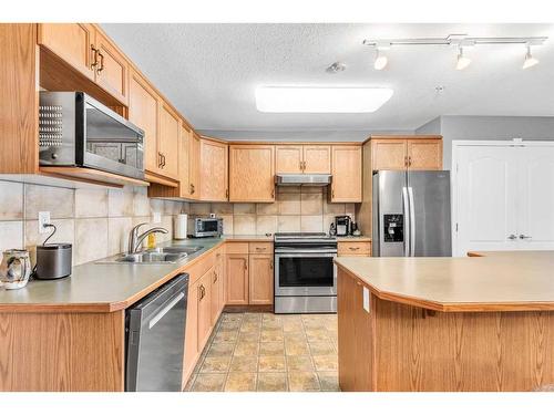 1315-303 Arbour Crest Drive Nw, Calgary, AB - Indoor Photo Showing Kitchen With Stainless Steel Kitchen With Double Sink