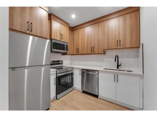 7108 36 Avenue Nw, Calgary, AB - Indoor Photo Showing Kitchen With Stainless Steel Kitchen With Double Sink