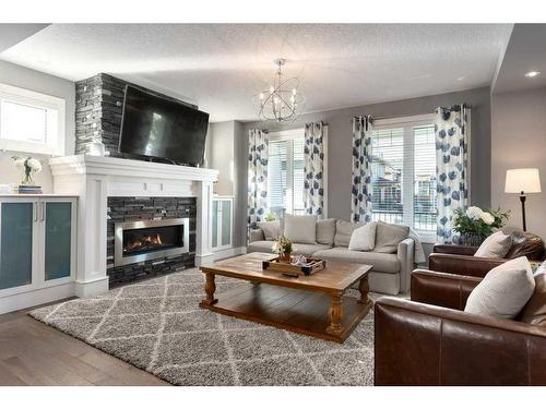 173 Brome Bend, Rural Rocky View County, AB - Indoor Photo Showing Living Room With Fireplace