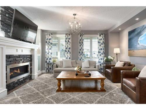 173 Brome Bend, Rural Rocky View County, AB - Indoor Photo Showing Living Room With Fireplace