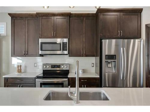 733 River Heights Crescent, Cochrane, AB - Indoor Photo Showing Kitchen With Stainless Steel Kitchen With Double Sink With Upgraded Kitchen