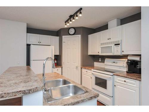 313-260 Shawville Way Se, Calgary, AB - Indoor Photo Showing Kitchen With Double Sink