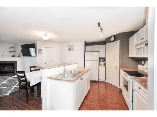 313-260 Shawville Way Se, Calgary, AB - Indoor Photo Showing Kitchen With Fireplace With Double Sink